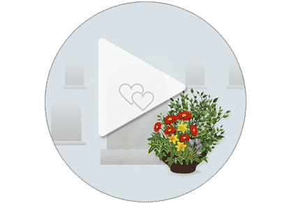Vidéo commémorative avec une urne et un bouquet de fleurs colorées en premier plan.